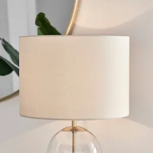 NORA Contemporary Clear Glass Table Lamp With Gold Chrome Details and Cream Shade Including A Rated Energy Efficient LED Bulb