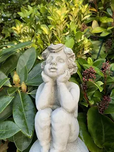 Adorable Stone Cast Boy on Ball Statue