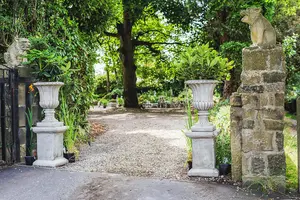 Pair of Large Stone Cast Flute Urns and Classic Plinths