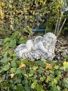 Vintage Cherub Statue Laying on a Grape