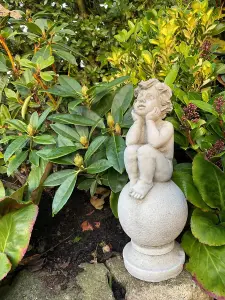 Adorable Stone Cast Boy on Ball Statue