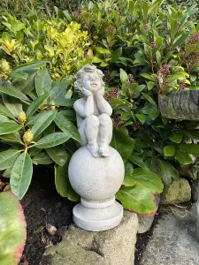 Adorable Stone Cast Boy on Ball Statue