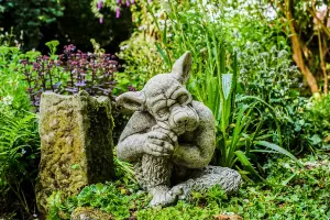 Solid cast Stone Dog Gargoyle In Sleepy Pose