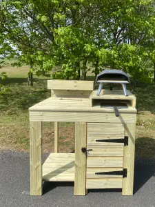 outdoor pizza oven table with built in cupboard storage, raised pizza stand and planter top