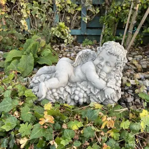 Vintage Cherub Statue Laying on a Grape