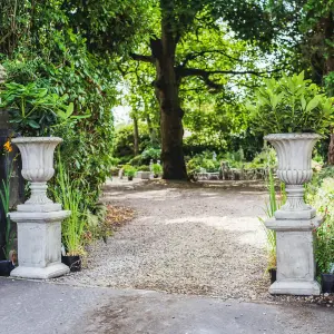 Pair of Large Stone Cast Flute Urns and Classic Plinths